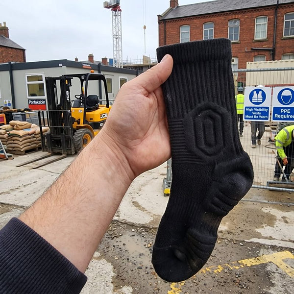 GroundGuard sock held up on a construction site